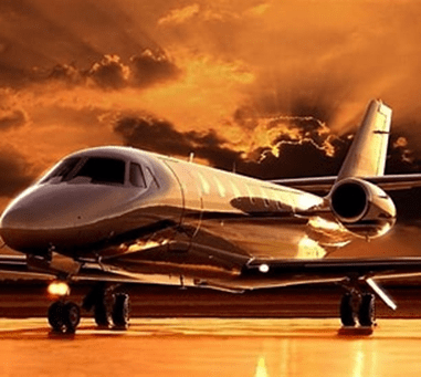 Luxurious private jet on a runway against a dramatic sunset sky. The sleek design highlights elegance and sophistication in air travel.