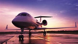 A sleek private jet on a runway against a vibrant sunset, reflecting luxury travel and modern aviation advancements.